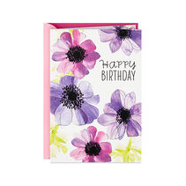 A card that reads happy birthday and features pastel flowers